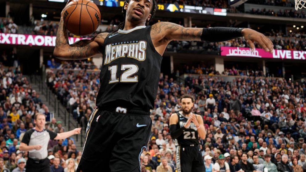 Memphis Grizzlies guard Ja Morant reacts after drawing a foul during the second half of the team's NBA basketball game against the Denver Nuggets on Tuesday, Dec. 20, 2022, in Denver. (AP Photo/David Zalubowski)