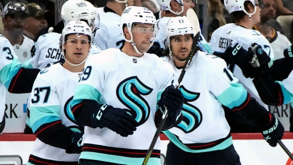 Seattle Kraken's Vince Dunn (29) returns to the bench after scoring during the second period of the team's NHL hockey game against the Pittsburgh Penguins in Pittsburgh, Saturday, Nov. 5, 2022. (AP Photo/{Gene J. Puskar})