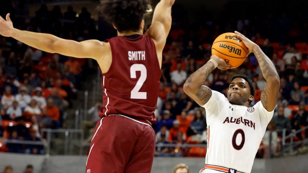 Auburn guard K.D. Johnson (0) shoots as Colgate guard Braeden Smith (2) defends during the second half of an NCAA college basketball game Friday, Dec. 2, 2022, in Auburn, Ala. (AP Photo/Butch Dill)