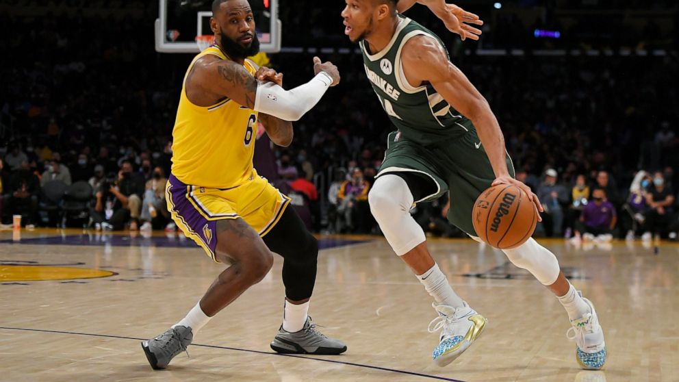 Los Angeles Lakers forward LeBron James (6) guards Milwaukee Bucks forward Giannis Antetokounmpo (34) in the first half in an NBA basketball game, Tuesday, Feb. 8, 2022, in Los Angeles. (AP Photo/John McCoy)