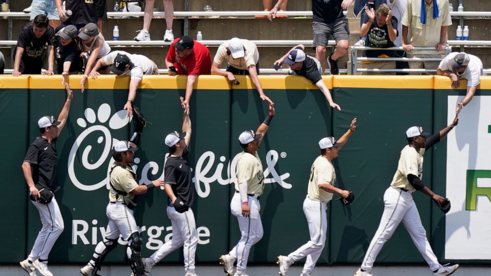 Vanderbilt players celebrate with fans after beating East Carolina in an NCAA college baseball super regional game Saturday, June 12, 2021, in Nashville, Tenn. Vanderbilt won 4-1 to sweep the three-game series and advance to the College World Series.