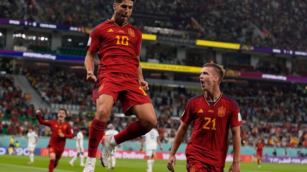 Spain's Marco Asensio, left, celebrates with Dani Olmo after scoring his side's second goal during the World Cup group E soccer match between Spain and Costa Rica, at the Al Thumama Stadium in Doha, Qatar, Wednesday, Nov. 23, 2022. (AP Photo/Alessand