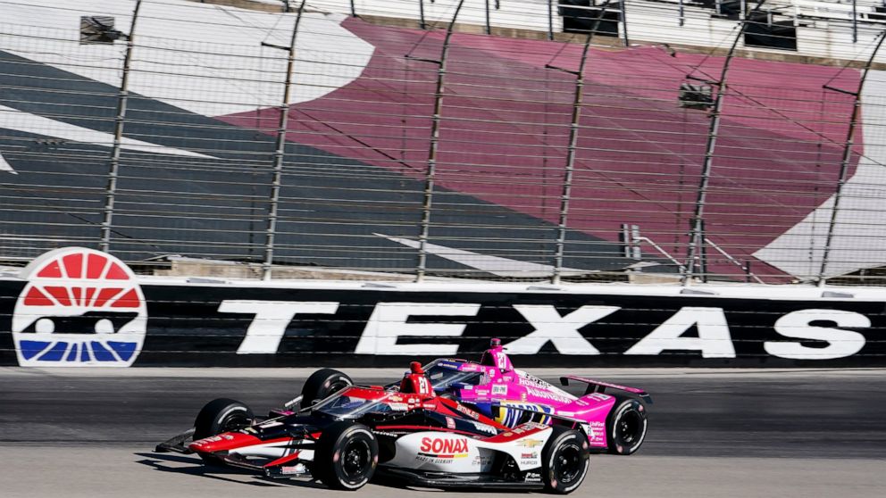 Rinus Veekay passes Alexander Rossi on the fourth turn during the first practice round of the IndyCar Series auto race at Texas Motor Speedway in Fort Worth, Texas on Saturday, March 19, 2022. (AP Photo/Larry Papke)