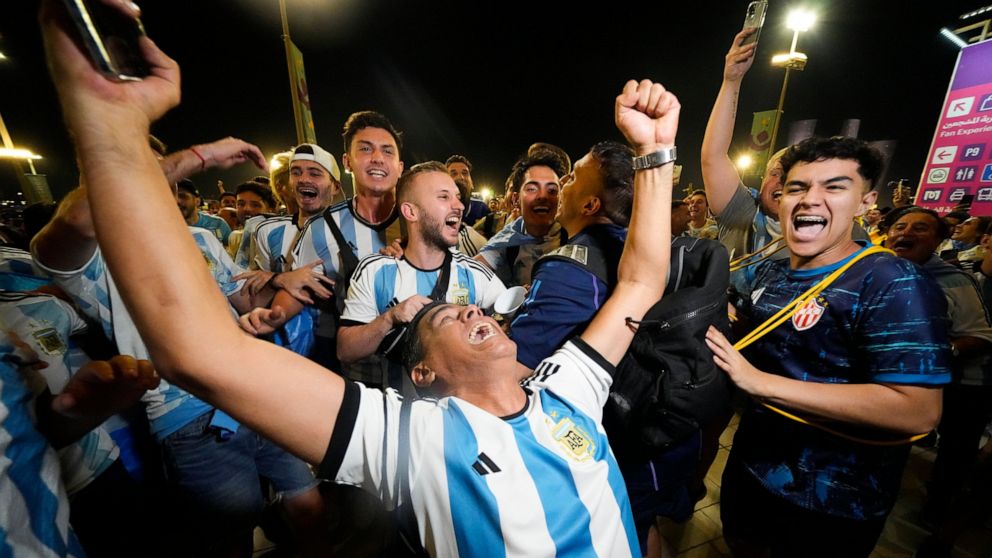 Supporters from Argentina celebrate outside Lusail Stadium following their team's 2-0 victory over Mexico in a World Cup group C soccer match in Lusail, Qatar, Saturday, Nov. 26, 2022. (AP Photo/Julio Cortez)
