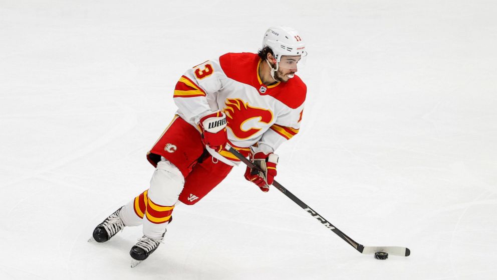 Calgary Flames left wing Johnny Gaudreau (13) looks to pass the puck against the Chicago Blackhawks during the first period of an NHL hockey game, Monday, April 18, 2022, in Chicago. (AP Photo/Kamil Krzaczynski)