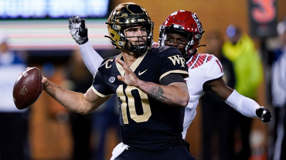 FILE - Wake Forest quarterback Sam Hartman plays against North Carolina State during the second half of an NCAA college football game Saturday, Nov. 13, 2021, in Winston-Salem, N.C. Hartman will miss “an extended period of time” for treatment of what