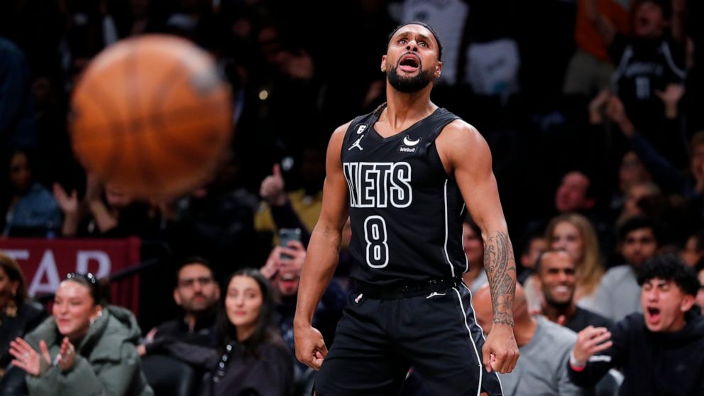 Brooklyn Nets guard Patty Mills (8) reacts after making a 3-point shot against the Toronto Raptors during the second half of an NBA basketball game Friday, Oct. 21, 2022, in New York. (AP Photo/Noah K. Murray)