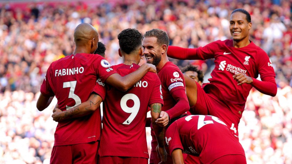 Liverpool's Roberto Firmino celebrates with his team-mates after scoring their side's seventh goal of the game during the English Premier League match between Liverpool and Bournemouth at Anfield stadium in Liverpool, England, Saturday Aug. 27, 2022.