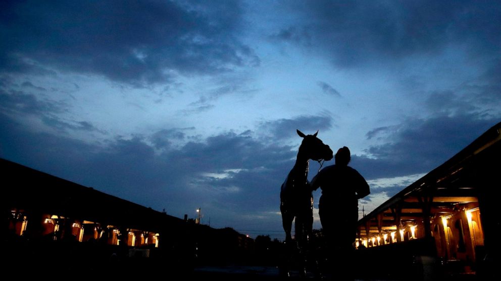 A horse gets a bath after an early-morning workout at Churchill Downs Tuesday, April 30, 2019, in Louisville, Ky. (AP Photo/Charlie Riedel, File)