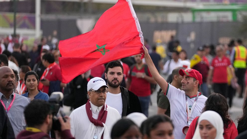 A Moroccan supporter waves his national flag as he arrives ahead of the World Cup quarterfinal soccer match between Morocco and Portugal, at Al Thumama Stadium in Doha, Qatar, Saturday, Dec. 10, 2022. (AP Photo/Jorge Saenz)