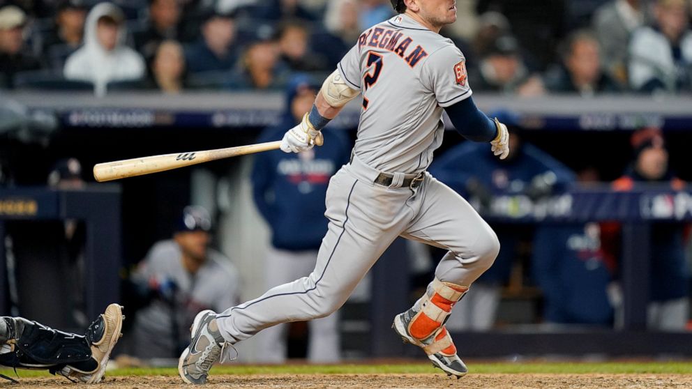 Houston Astros Alex Bregman (2) follows through on a base hit to drive in a run against the New York Yankees during the seventh inning of Game 4 of an American League Championship baseball series, Sunday, Oct. 23, 2022, in New York. (AP Photo/John Mi
