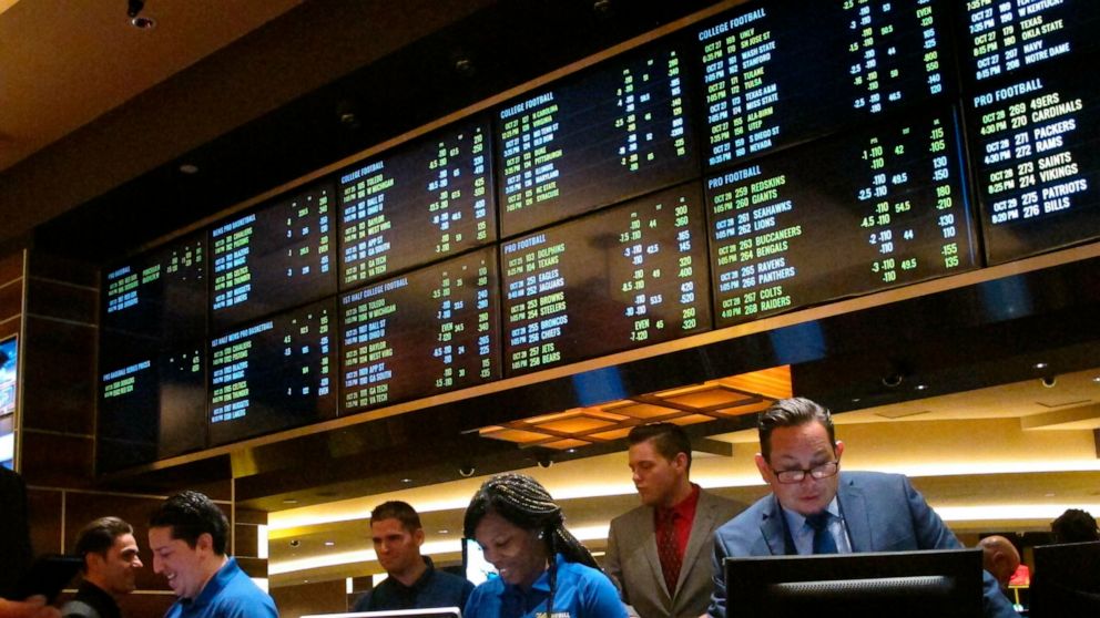 This Oct. 25, 2018 photo shows employees at the new sports book at the Tropicana casino in Atlantic City N.J., preparing to take bets moments before it opened. NBA and MLB executives staunchly believe their leagues deserve a cut of sports betting rev