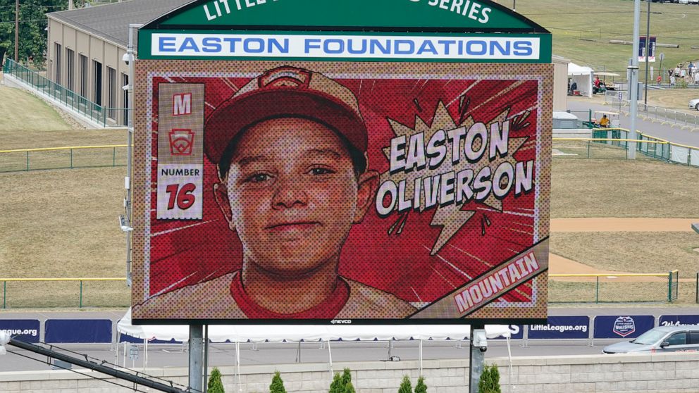 FILE- An image of Mountain Region Champion Little League team member Easton Oliverson is displayed on the scoreboard at Volunteer Stadium during the opening ceremony of the 2022 Little League World Series baseball tournament in South Williamsport, Pa