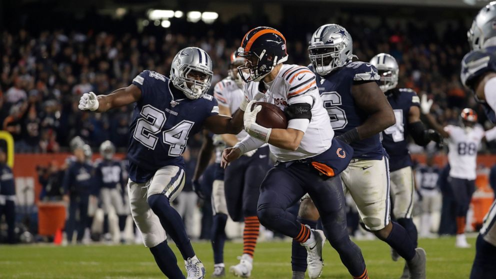 Chicago Bears quarterback Mitchell Trubisky (10) runs in for a touchdown against Dallas Cowboys' Chidobe Awuzie (24) during the second half of an NFL football game, Thursday, Dec. 5, 2019, in Chicago. (AP Photo/Morry Gash)