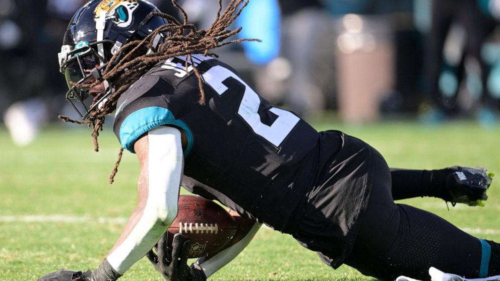 Jacksonville Jaguars safety Rayshawn Jenkins (2) intercepts a pass during the second half of an NFL football game against the Dallas Cowboys, Sunday, Dec. 18, 2022, in Jacksonville, Fla. (AP Photo/Phelan M. Ebenhack)
