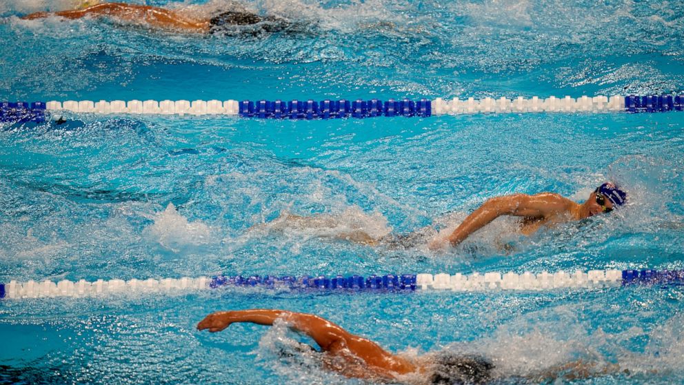 FILE - Swimmers compete during the U.S. Olympic Swim Trials in Omaha, Neb., on June 20, 2021. USA Swimming has added technology to its abuse-reporting systems that will allow better communication between investigators and reporters who want to remain