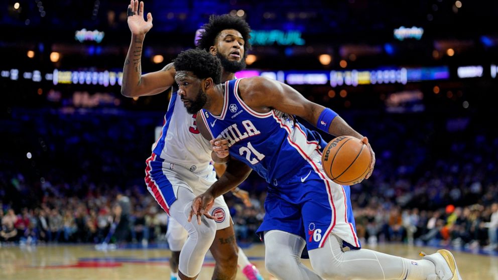 Philadelphia 76ers' Joel Embiid, right, tries to get past Detroit Pistons' Marvin Bagley III during the first half of an NBA basketball game, Wednesday, Dec. 21, 2022, in Philadelphia. (AP Photo/Matt Slocum)