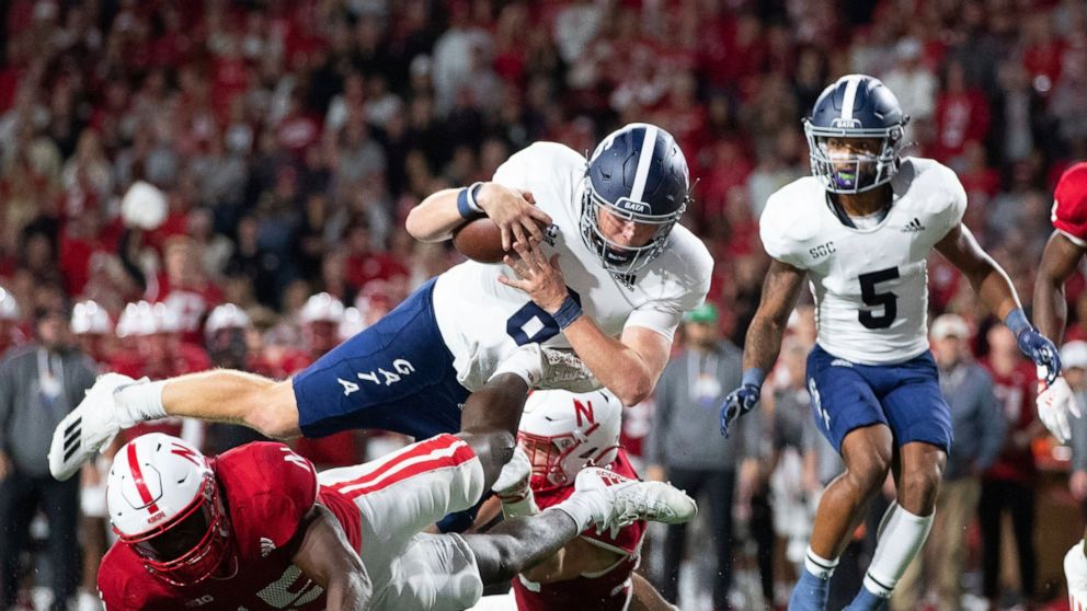 Georgia Southern quarterback Kyle Vantrease (6) leaps over Nebraska's Ernest Hausmann (15) to score a touchdown during the second half of an NCAA college football game Saturday, Sept. 10, 2022, in Lincoln, Neb. Georgia Southern won 45-42. (AP Photo/R