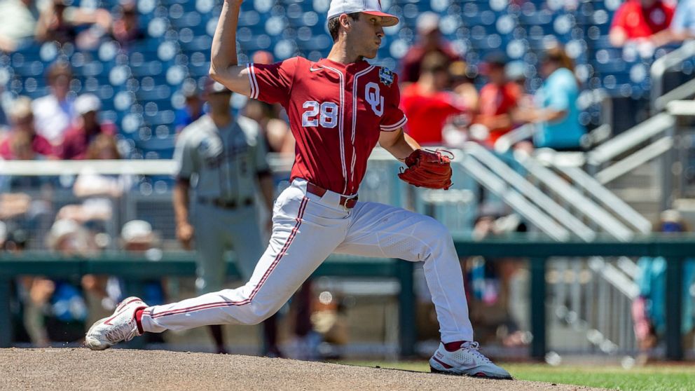 Oklahoma starting pitcher David Sandlin (28) throws a pitch against Texas A&M in the first inning during an NCAA College World Series baseball game Wednesday, June 22, 2022, in Omaha, Neb. (AP Photo/John Peterson)