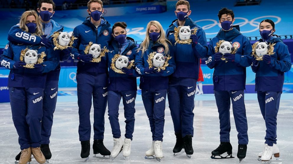 Silver medalists Team United States stand pose for a group photo following the victory ceremony after the team event in the figure skating competition at the 2022 Winter Olympics, Monday, Feb. 7, 2022, in Beijing. (AP Photo/David J. Phillip)