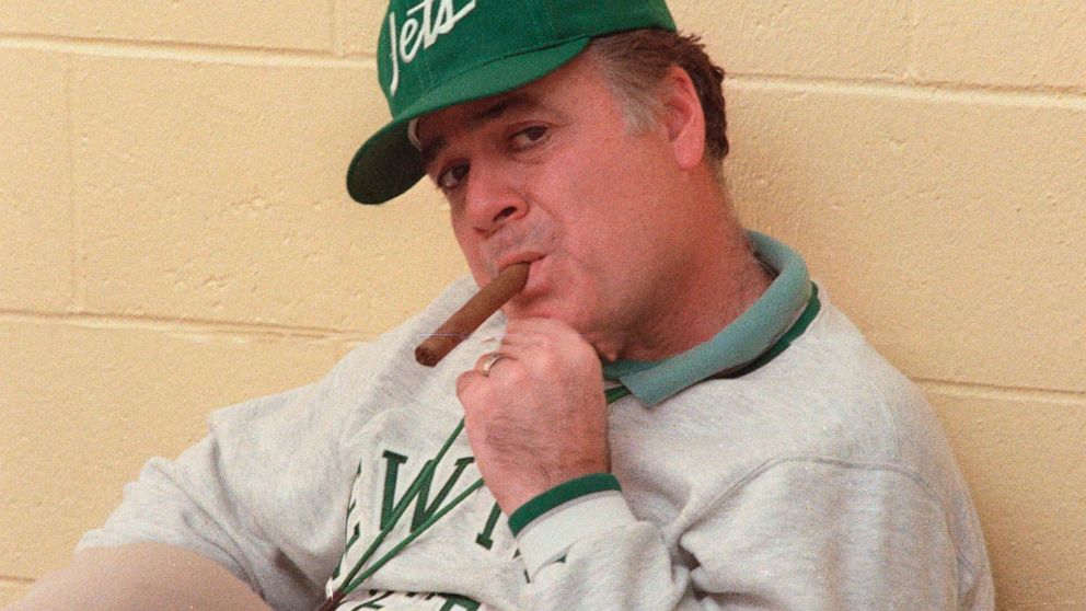 FILE - in this Dec. 31, 1986 file photo, New York Jets coach Joe Walton smokes a cigar during an interview at Hofstra University in West Hempstead, N.Y. Walton, the former New York Jets coach who built Robert Morris University’s football program from