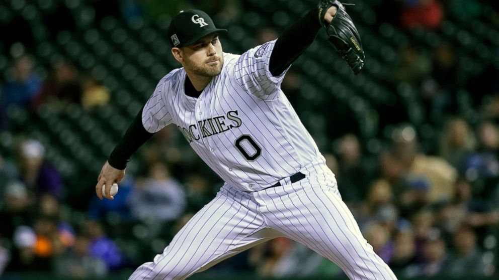 FILE - In this June 19, 2018, file photo, Colorado Rockies relief pitcher Adam Ottavino throws against the New York Mets during the seventh inning of a baseball game in Denver. A person familiar with the negotiations says reliever Adam Ottavino and t