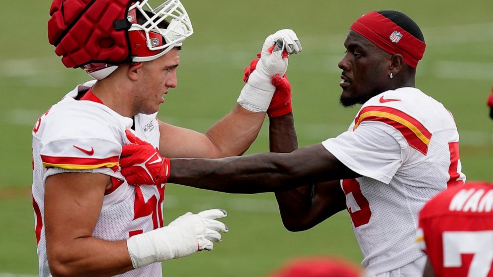 Kansas City Chiefs defensive end George Karlaftis, left, works with defensive end Frank Clark, right, during NFL football training camp Monday, Aug. 15, 2022, in St. Joseph, Mo. (AP Photo/Charlie Riedel)