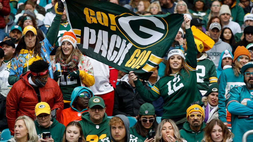 Green Bay Packers fans cheer on their team during the first half of an NFL football game against the Miami Dolphins, Sunday, Dec. 25, 2022, in Miami Gardens, Fla. (AP Photo/Rhona Wise)