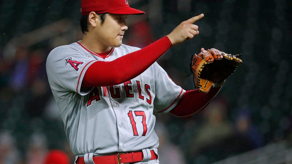 Los Angeles Angels starting pitcher Shohei Ohtani signals to the catcher after throwing his 200th strikeout of the season, during the fourth inning of the team's baseball game against the Minnesota Twins on Friday, Sept. 23, 2022, in Minneapolis. (AP