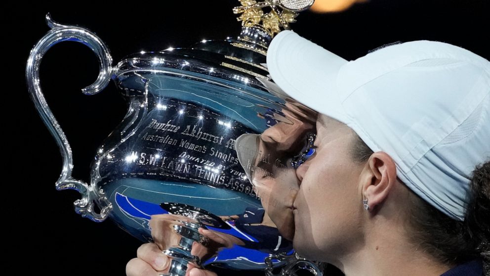 FILE - Ash Barty of Australia kisses the Daphne Akhurst Memorial Cup after defeating Danielle Collins of the U.S in the women's singles final at the Australian Open tennis championships in Melbourne, Australia on Jan. 29, 2022. In a shock announcemen