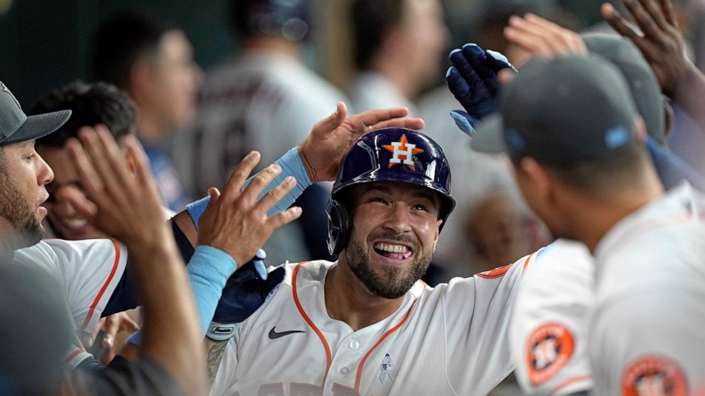 Houston Astros' J.J. Matijevic celebrates with teammates in the dugout after hitting a home run against the Chicago White Sox during the fourth inning of a baseball game Sunday, June 19, 2022, in Houston. Matijevic's home run was his first Major Leag