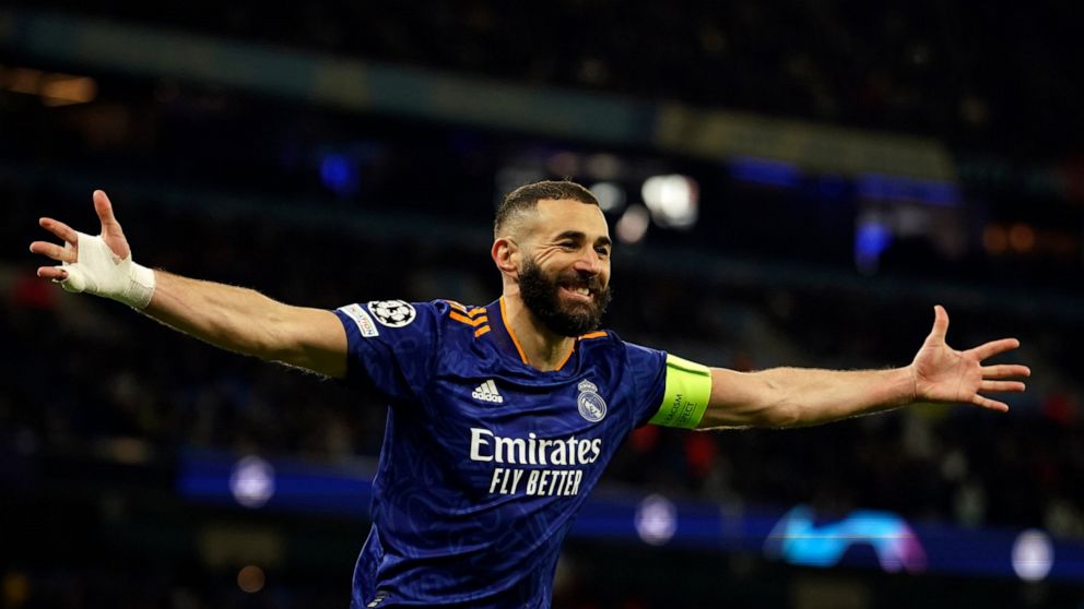 Real Madrid's Karim Benzema celebrates after scoring his side's third goal from penalty during the Champions League semi final, first leg soccer match between Manchester City and Real Madrid at the Etihad stadium in Manchester, England, Tuesday, Apri