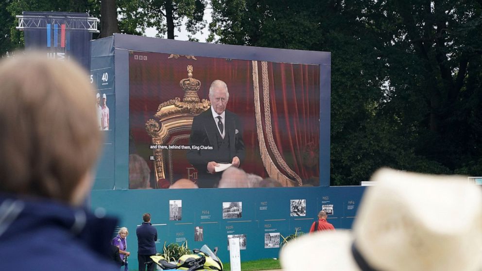 Spectators watch the Accession Council, where King Charles III is formally proclaimed monarch, on the big screen at Wentworth Golf Club, Virginia Water, Britain, Saturday, Sept. 10, 2022. (Adam Davy/PA via AP)
