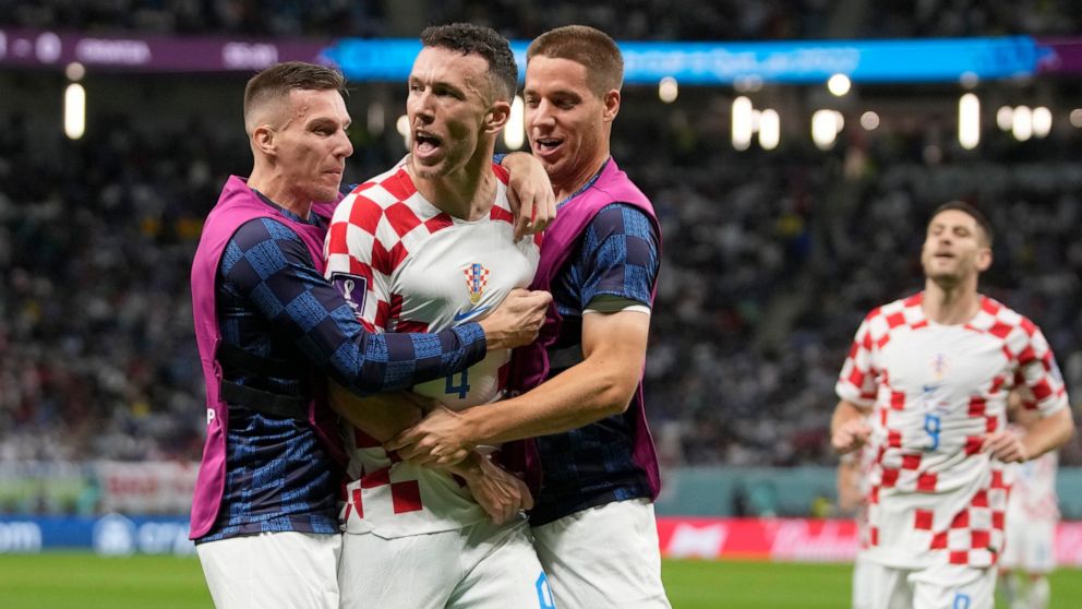 Croatia's Ivan Perisic, second left, celebrates with teammates after scoring his side's opening goal during the World Cup round of 16 soccer match between Japan and Croatia at the Al Janoub Stadium in Al Wakrah, Qatar, Monday, Dec. 5, 2022. (AP Photo