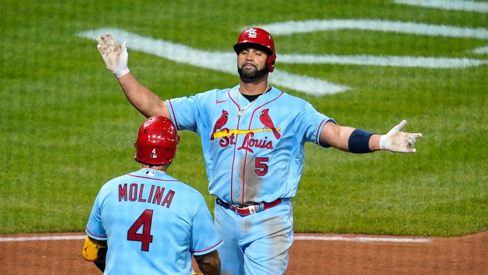 St. Louis Cardinals' Albert Pujols (5) is greeted by Yadier Molina (4) after hitting a two-run home run off Pittsburgh Pirates starting pitcher JT Brubaker during the sixth inning of a baseball game in Pittsburgh, Saturday, Sept. 10, 2022. (AP Photo/