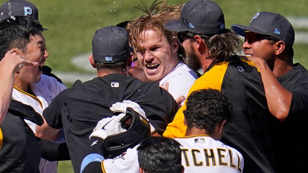 Pittsburgh Pirates' Jack Suwinski, center, is swarmed by teammates after hitting a walkoff solo home run off San Francisco Giants relief pitcher Tyler Rogers during the ninth inning of a baseball game in Pittsburgh, Sunday, June 19, 2022. It was Suwi