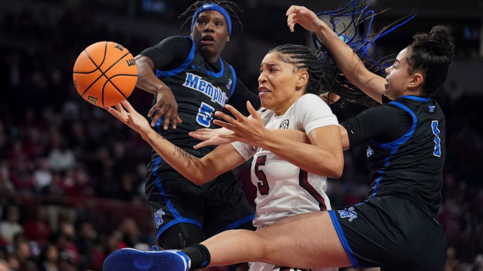 South Carolina forward Victaria Saxton (5) battles for the ball with Memphis forward Hannah Riddick (1) and Emani Jefferson (5) during the first half of an NCAA college basketball game Saturday, Dec. 3, 2022, in Columbia, S.C. (AP Photo/Sean Rayford)