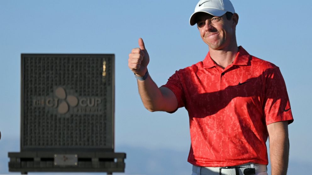 FILE - Rory McIlroy, of Northern Ireland, gestures near the tournament trophy after winning the CJ Cup golf tournament on Oct. 17, 2021, in Las Vegas. McIlroy defends his title starting Thursday, Oct. 20, 2022, when the CJ Cup moves to South Carolina