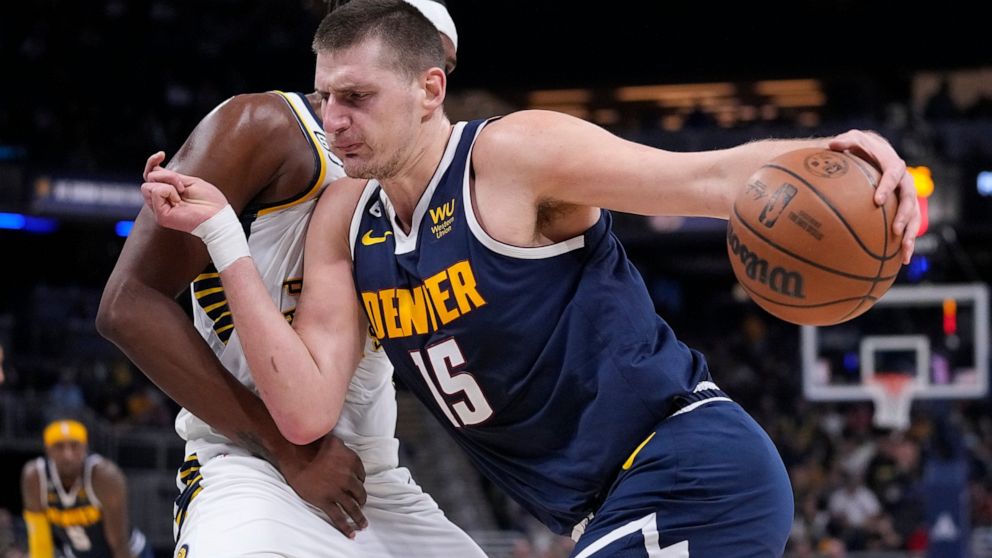 Denver Nuggets' Nikola Jokic (15) goes to the basket against Indiana Pacers' Myles Turner during the first half of an NBA basketball game, Wednesday, Nov. 9, 2022, in Indianapolis. (AP Photo/Darron Cummings)