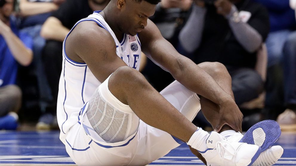 Duke's Zion Williamson sits on the floor following a injury during the first half of an NCAA college basketball game against North Carolina in Durham, N.C., Wednesday, Feb. 20, 2019. 