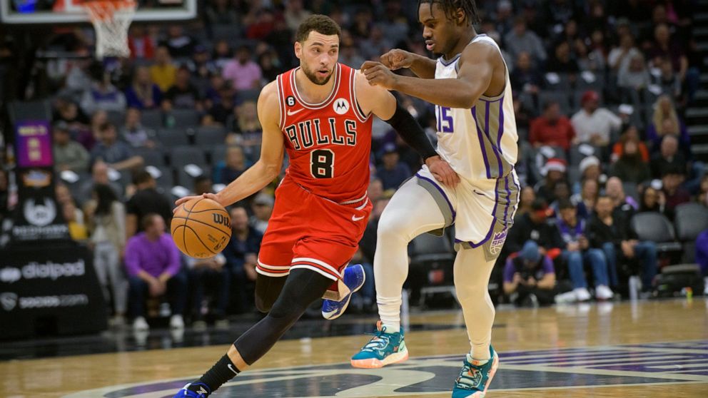 Chicago Bulls guard Zach LaVine (8) is guarded by Sacramento Kings guard Davion Mitchell (15) during the first quarter of an NBA basketball game in Sacramento, Calif., Sunday, Dec. 4, 2022. (AP Photo/Randall Benton)