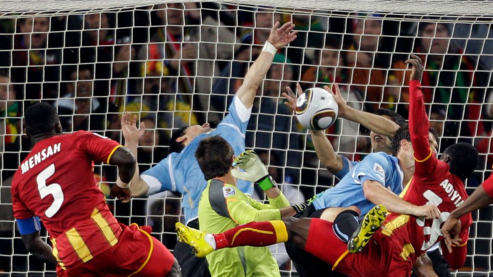 FILE - Uruguay's Luis Suarez, right, stops the ball with his hands to give away a penalty kick during the World Cup quarterfinal soccer match between Uruguay and Ghana at Soccer City in Johannesburg, South Africa, Friday, July 2, 2010. (AP Photo/Fern