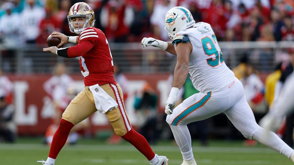 San Francisco 49ers quarterback Brock Purdy, left, passes against Miami Dolphins defensive tackle Zach Sieler during the first half of an NFL football game in Santa Clara, Calif., Sunday, Dec. 4, 2022. (AP Photo/Jed Jacobsohn)
