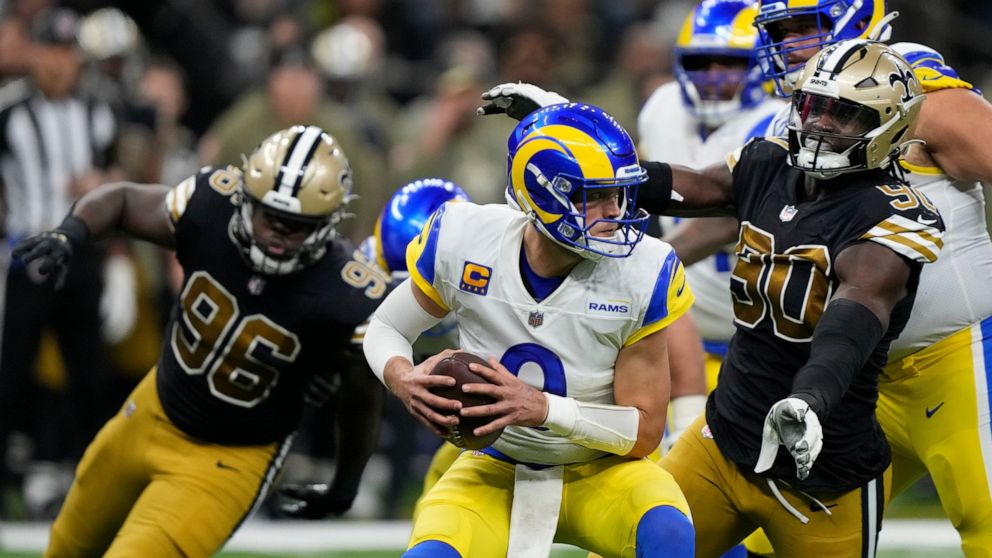 Los Angeles Rams quarterback Matthew Stafford, center, is sacked by New Orleans Saints defensive end Tanoh Kpassagnon (90) in the second half of an NFL football game in New Orleans, Sunday, Nov. 20, 2022. (AP Photo/Gerald Herbert)