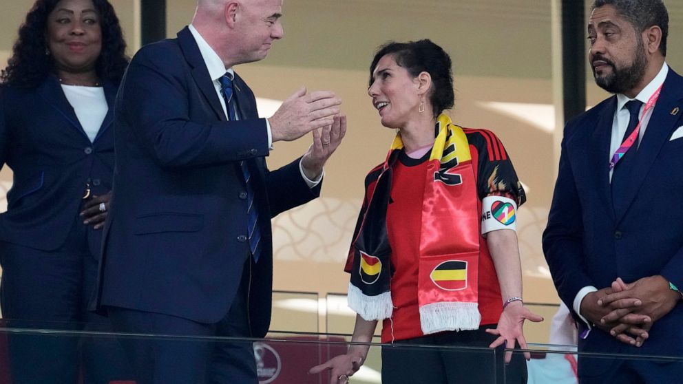Belgium Foreign Minister Hadja Lahbib, wearing a "One Love" armband, talks with FIFA President Gianni Infantino, left, on the tribune during the World Cup group F soccer match between Belgium and Canada, at the Ahmad Bin Ali Stadium in Doha, Qatar, W