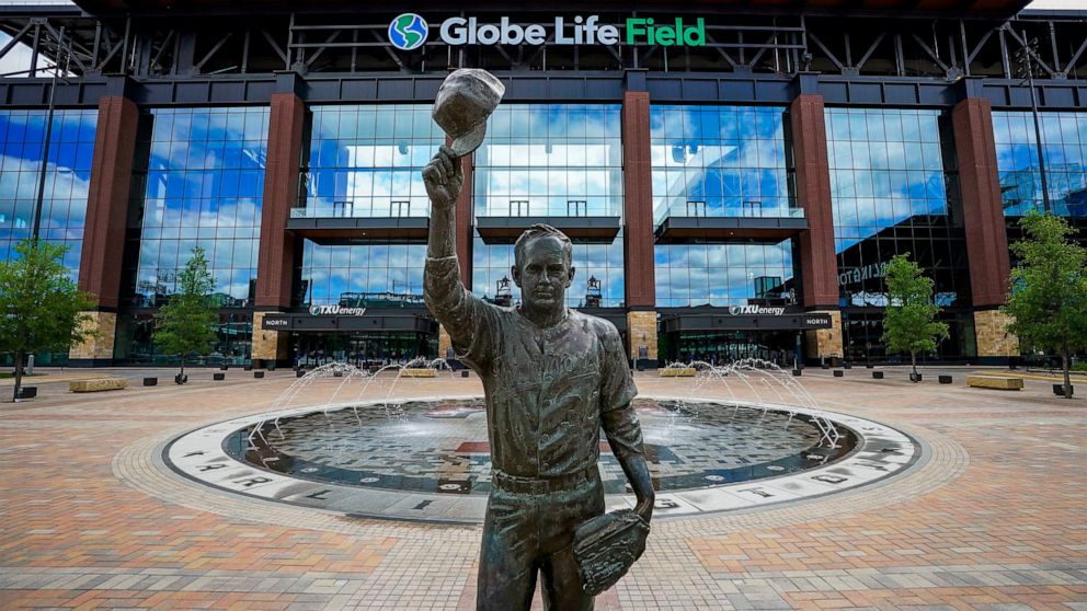 FILE - In this March 31, 2020, file photo, a statue of Nolan Ryan stands in the empty plaza outside Globe Life Field in Arlington, Texas. The new Texas Rangers ballpark is among possible venues Major League Baseball could use if it decides to start t