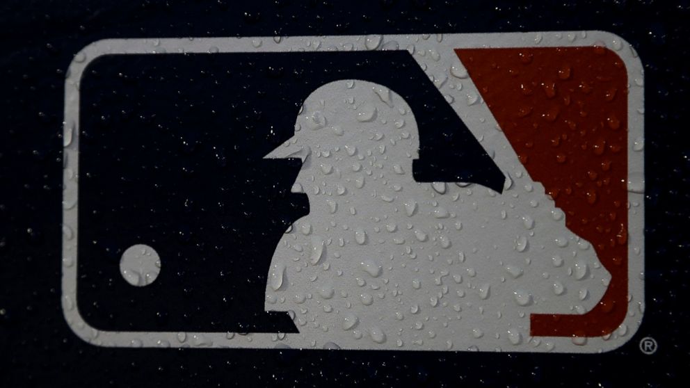 FILE - A rain-covered logo is seen at Fenway Park before Game 1 of the World Series baseball game between the Boston Red Sox and the Los Angeles Dodgers Tuesday, Oct. 23, 2018, in Boston. Major League Baseball has stopped testing players for steroids