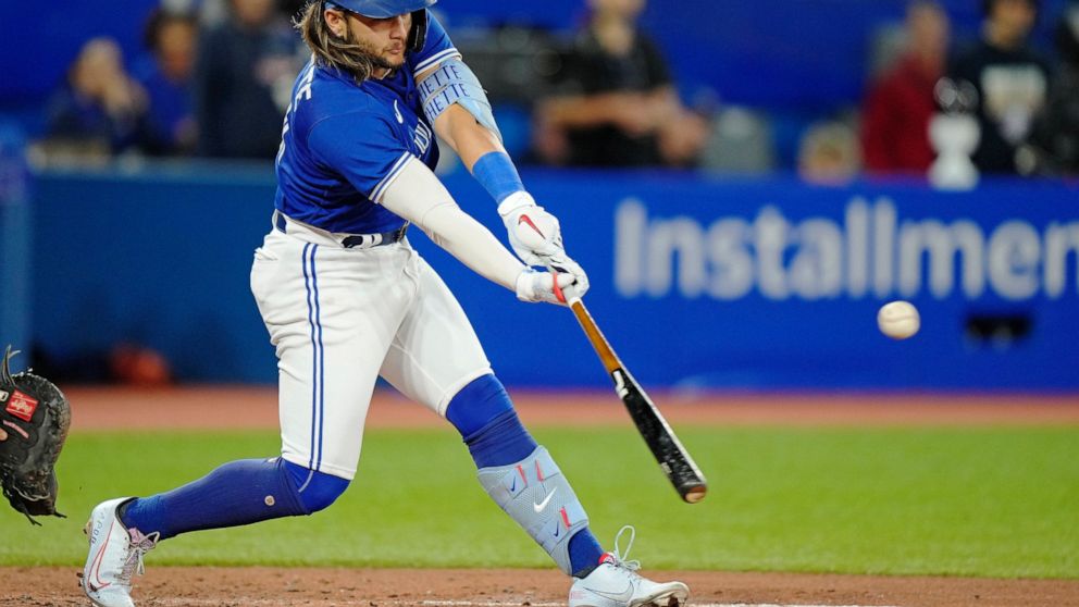 Toronto Blue Jays' Bo Bichette hits an RBI single against the Tampa Bay Rays during the third inning of a baseball game Wednesday, Sept. 14, 2022, in Toronto. (Frank Gunn/The Canadian Press via AP)
