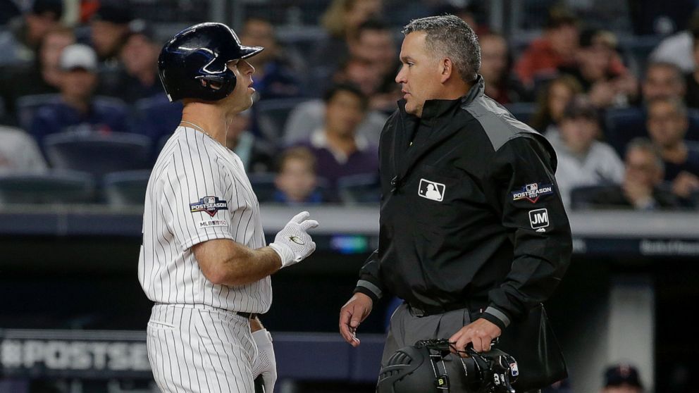 New York Yankees' Brett Gardner, left, talks with home plate umpire Manny Gonzalez after striking out against the Minnesota Twins during the first inning of Game 1 of an American League Division Series baseball game, Friday, Oct. 4, 2019, in New York