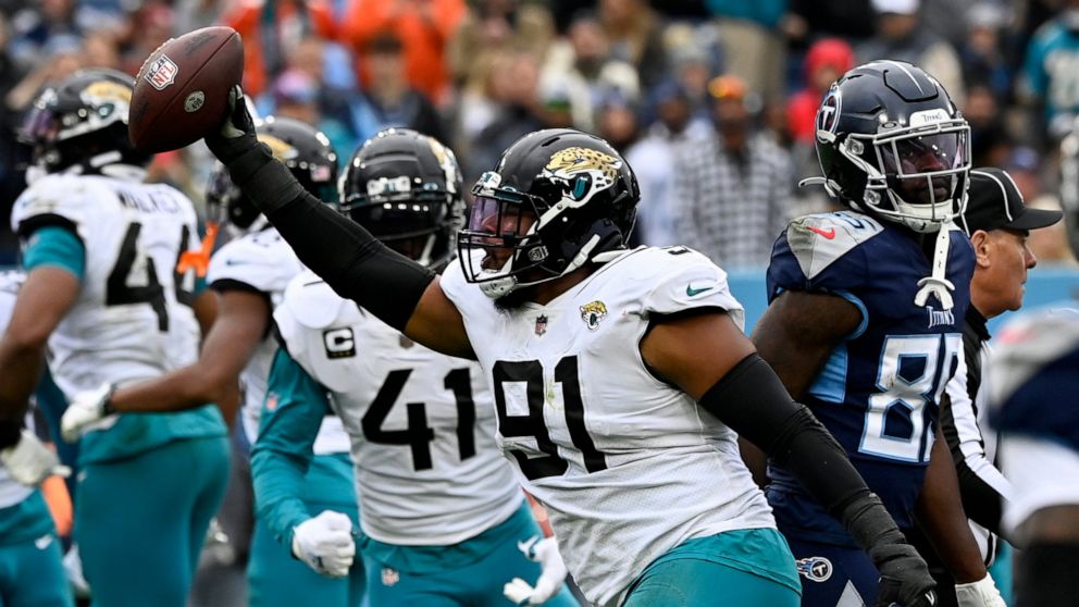 Jacksonville Jaguars defensive end Dawuane Smoot (91) celebrates after recovering a fumble by Tennessee Titans quarterback Ryan Tannehill during the first half of an NFL football game Sunday, Dec. 11, 2022, in Nashville, Tenn. (AP Photo/Mark Zaleski)